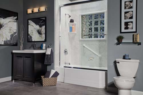 Gray walled bathroom with glass wall shower