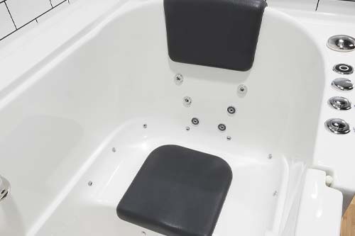 White walk in bathtub with seat padding.