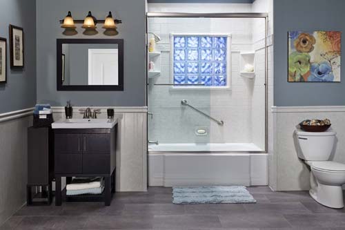 Blue walled bathroom with shower and toilet.