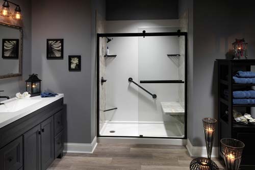 gray walled bathroom with glass wall shower.